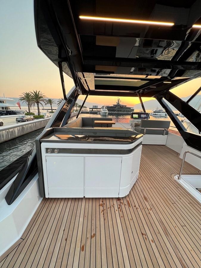 a deck with a grill and a deck with a view of the water aboard AISULU Yacht for Sale