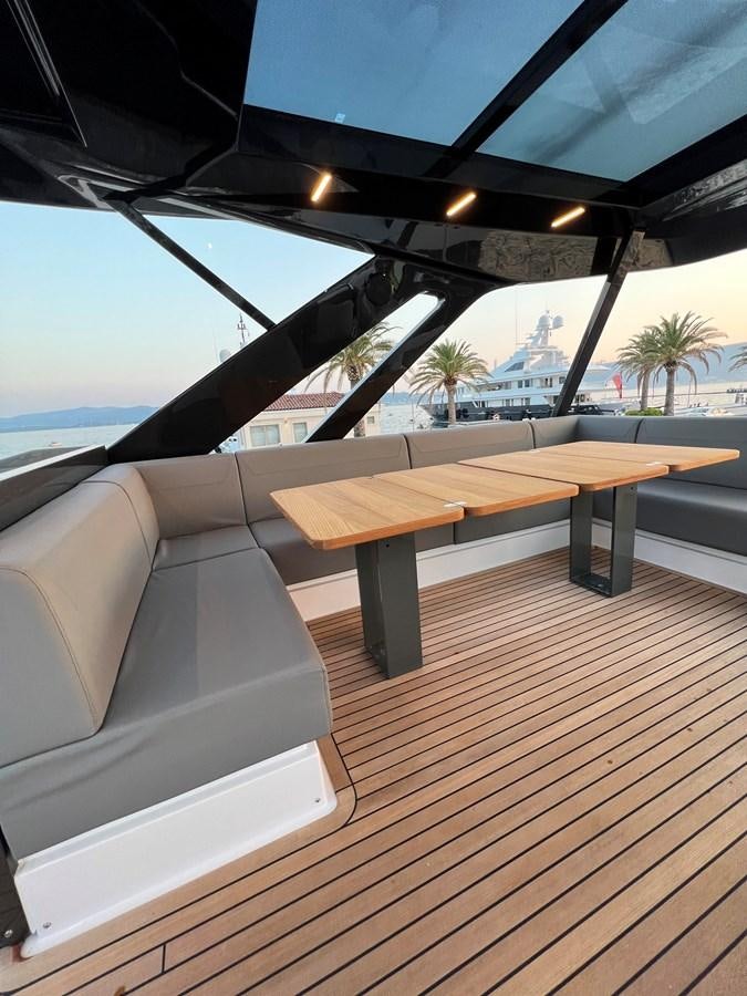 a wood deck with a view of the ocean and a beach aboard AISULU Yacht for Sale