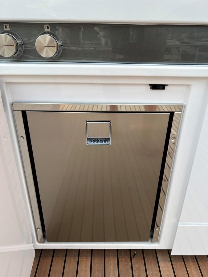 a white cabinet with a vent aboard AISULU Yacht for Sale