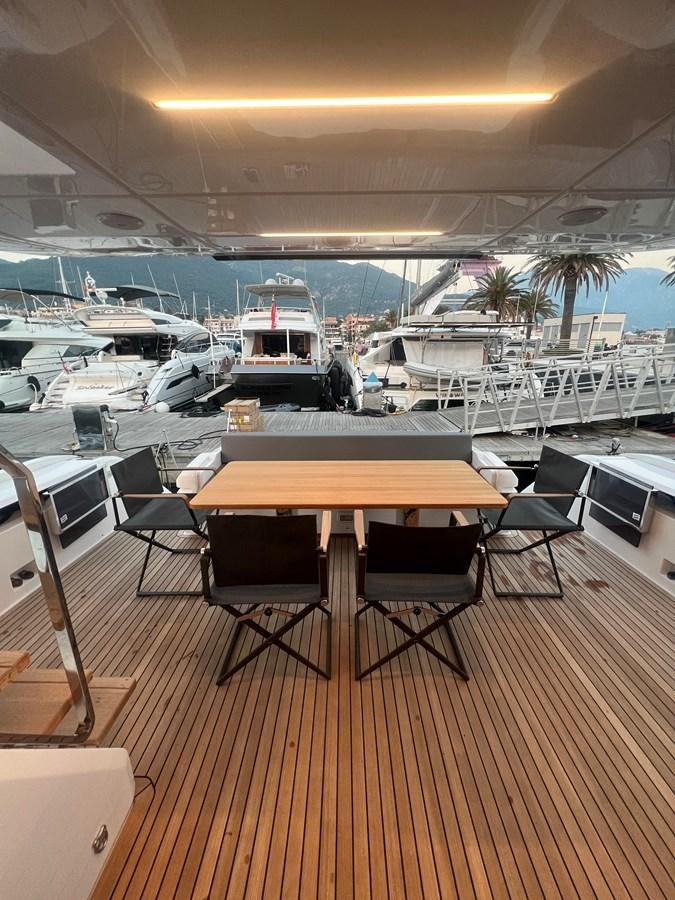 a boat dock with tables and chairs aboard AISULU Yacht for Sale
