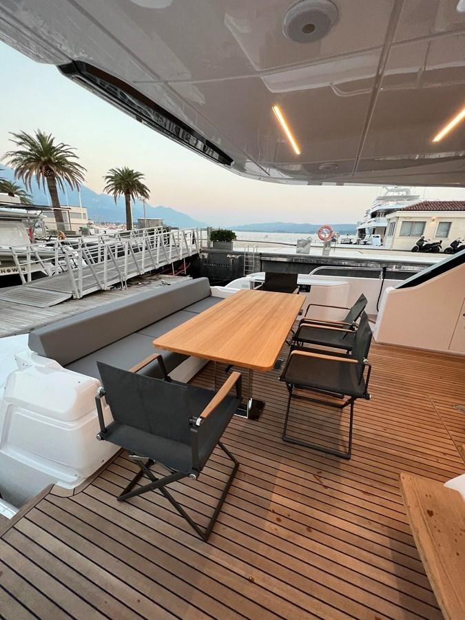 a table and chairs on a deck aboard AISULU Yacht for Sale