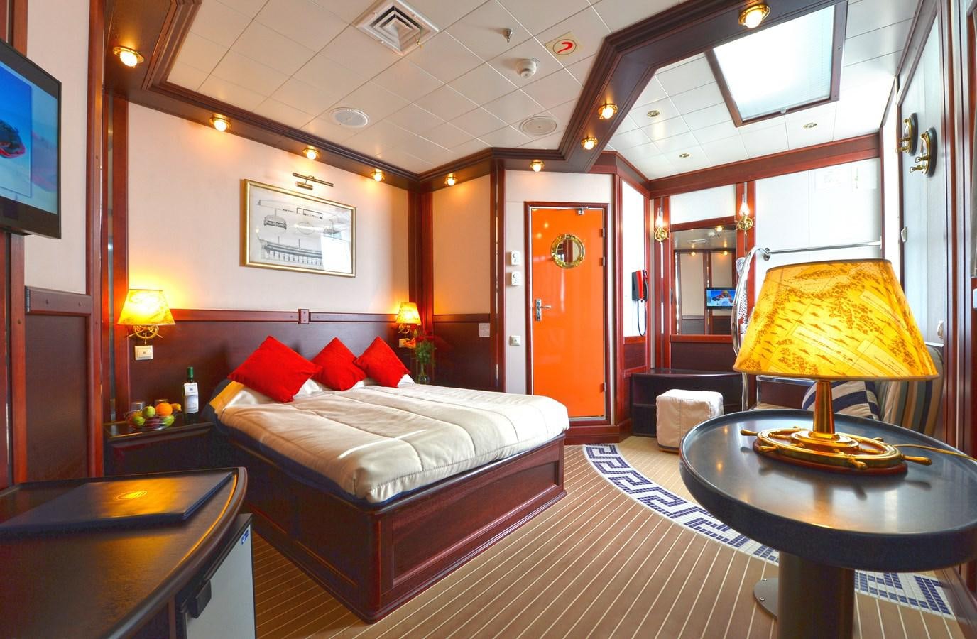 a hotel room with a bed and a lamp aboard RUNNING ON WAVES Yacht for Sale
