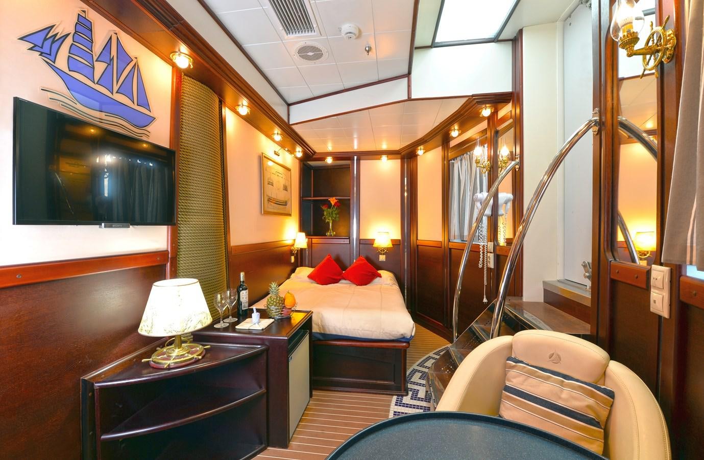 a room with a bed and a desk aboard RUNNING ON WAVES Yacht for Sale