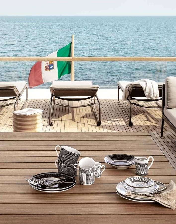 a table with plates and cups on it by the ocean aboard 2017 SANLORENZO SL86 # 676 Yacht for Sale