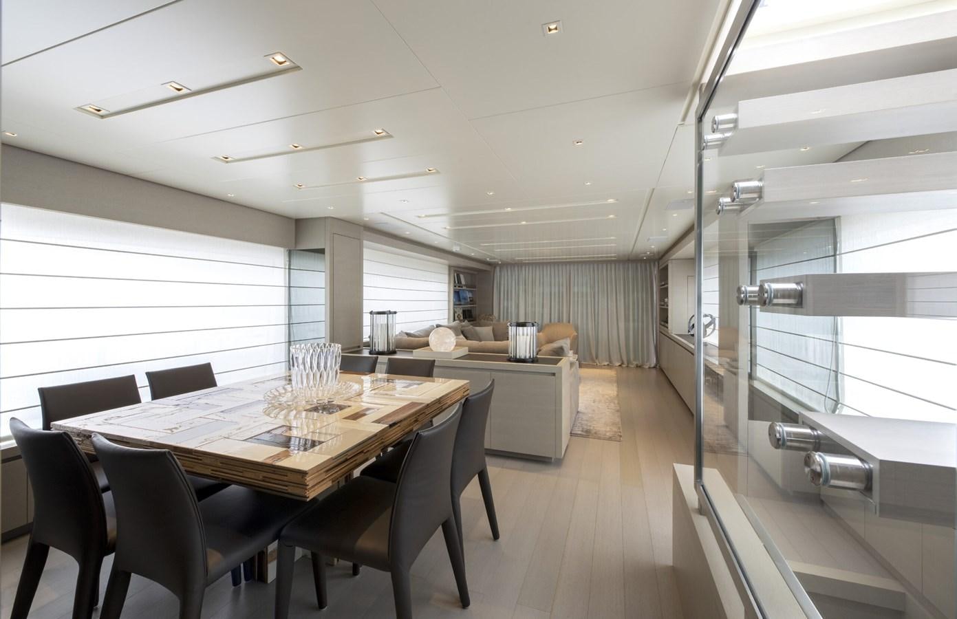 a large room with a table and chairs aboard 2017 SANLORENZO SL86 # 676 Yacht for Sale