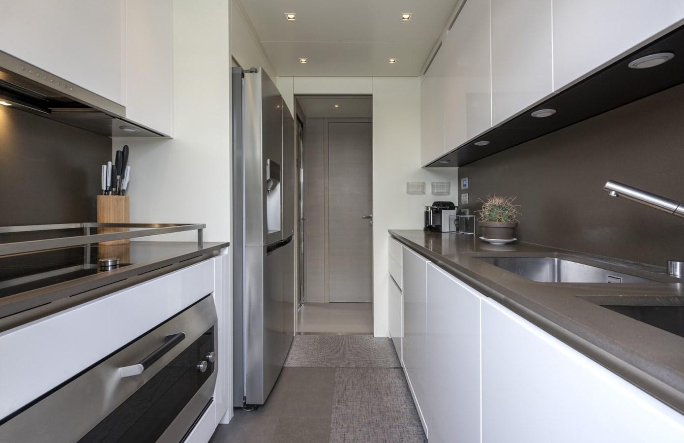 a kitchen with white cabinets aboard 2017 SANLORENZO SL86 # 676 Yacht for Sale