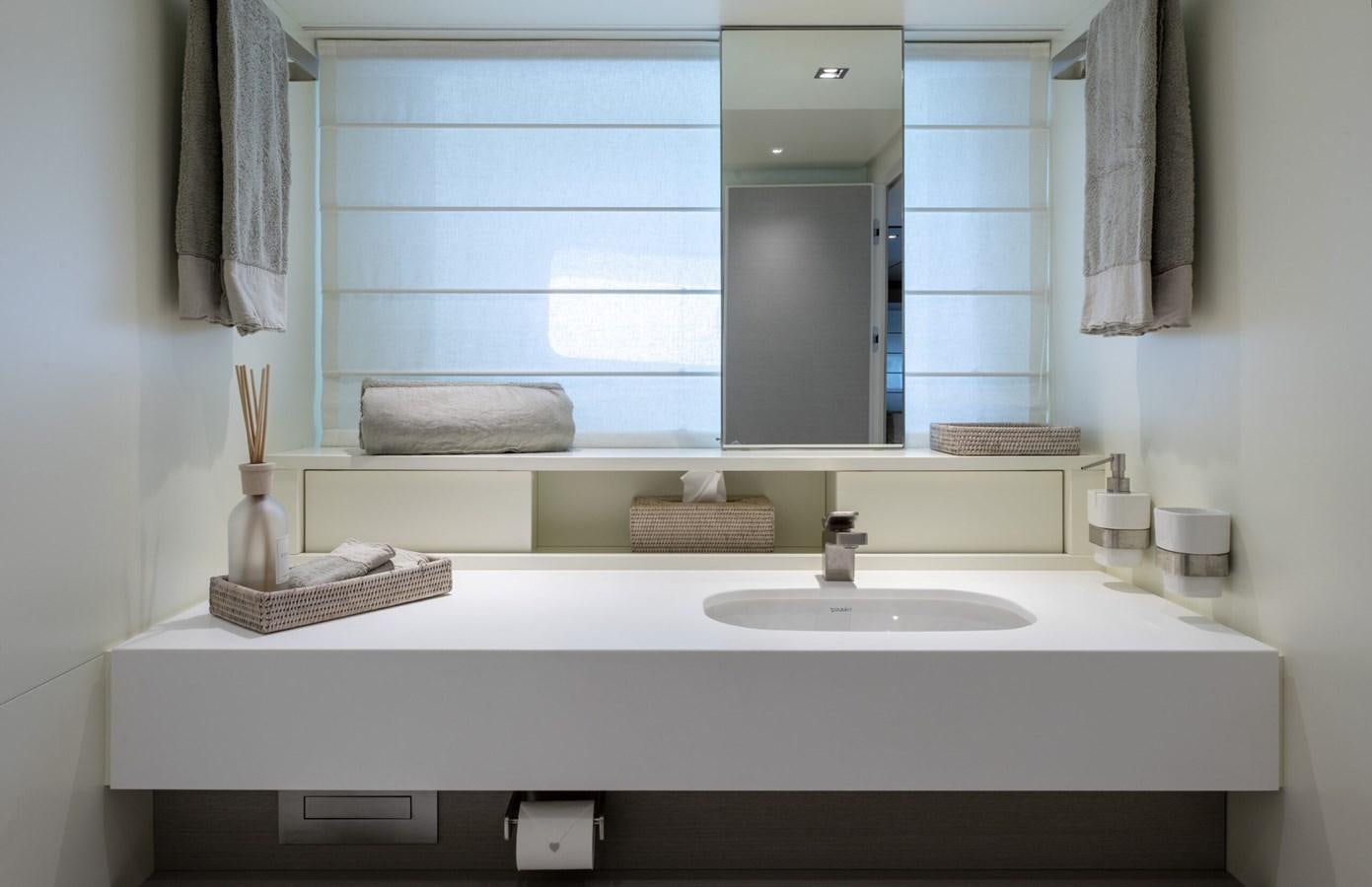 a bathroom with a sink and mirror aboard 2017 SANLORENZO SL86 # 676 Yacht for Sale