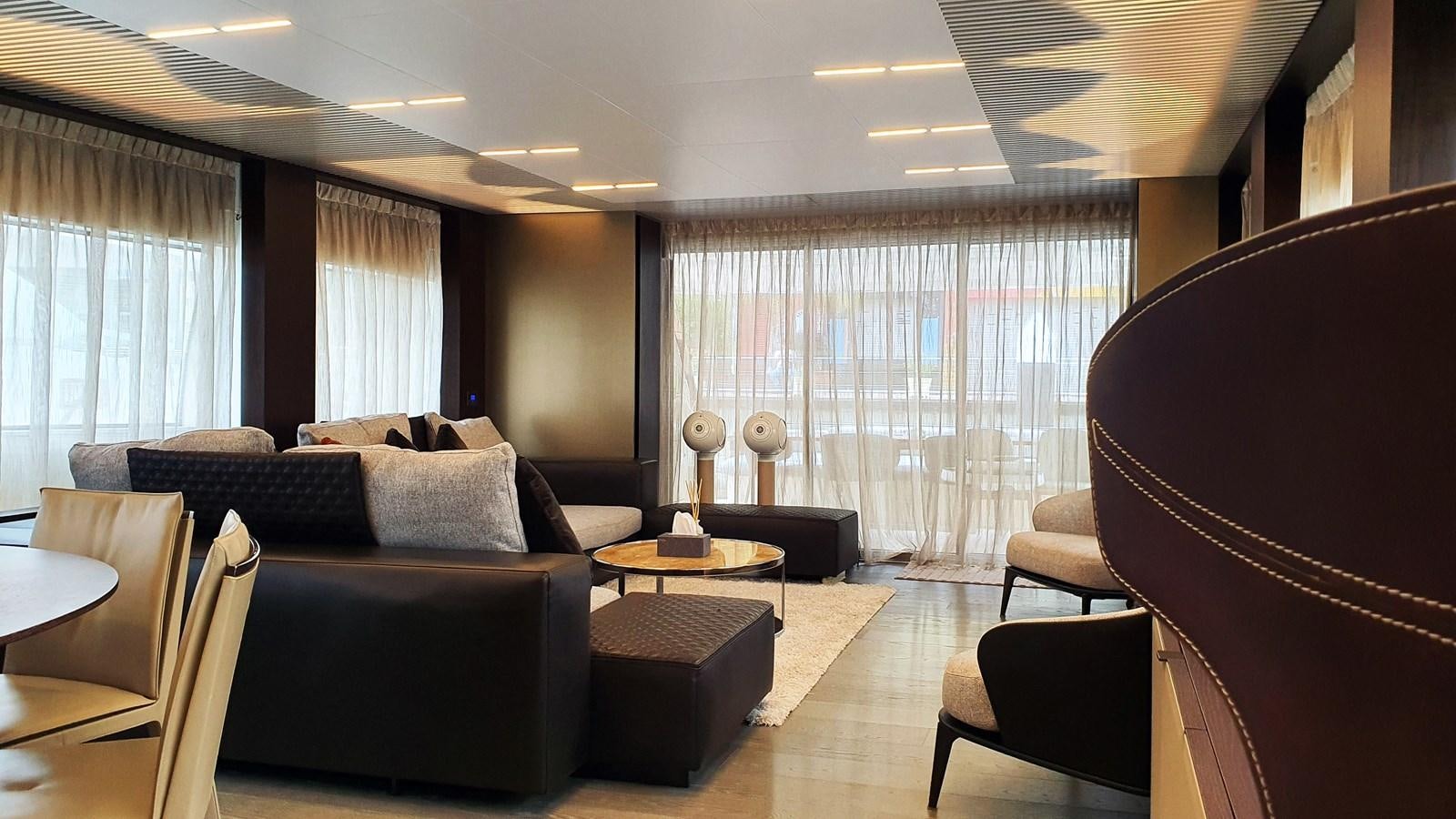 a living room with a couch and a piano aboard WHITE SHARK Yacht for Sale