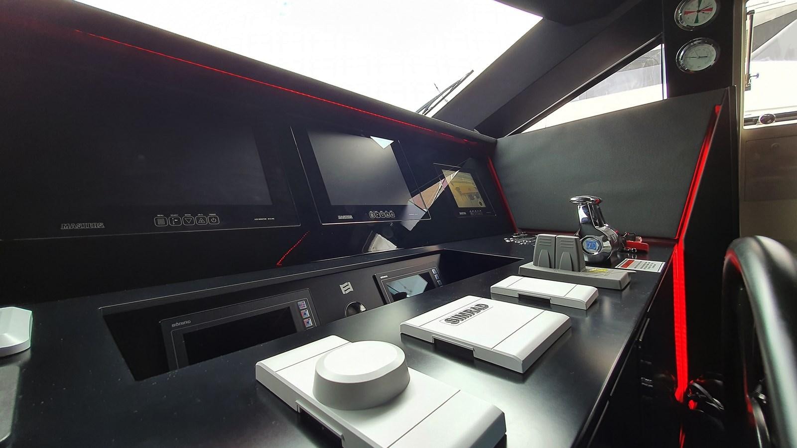 a black computer monitor and a white box on a white table aboard WHITE SHARK Yacht for Sale