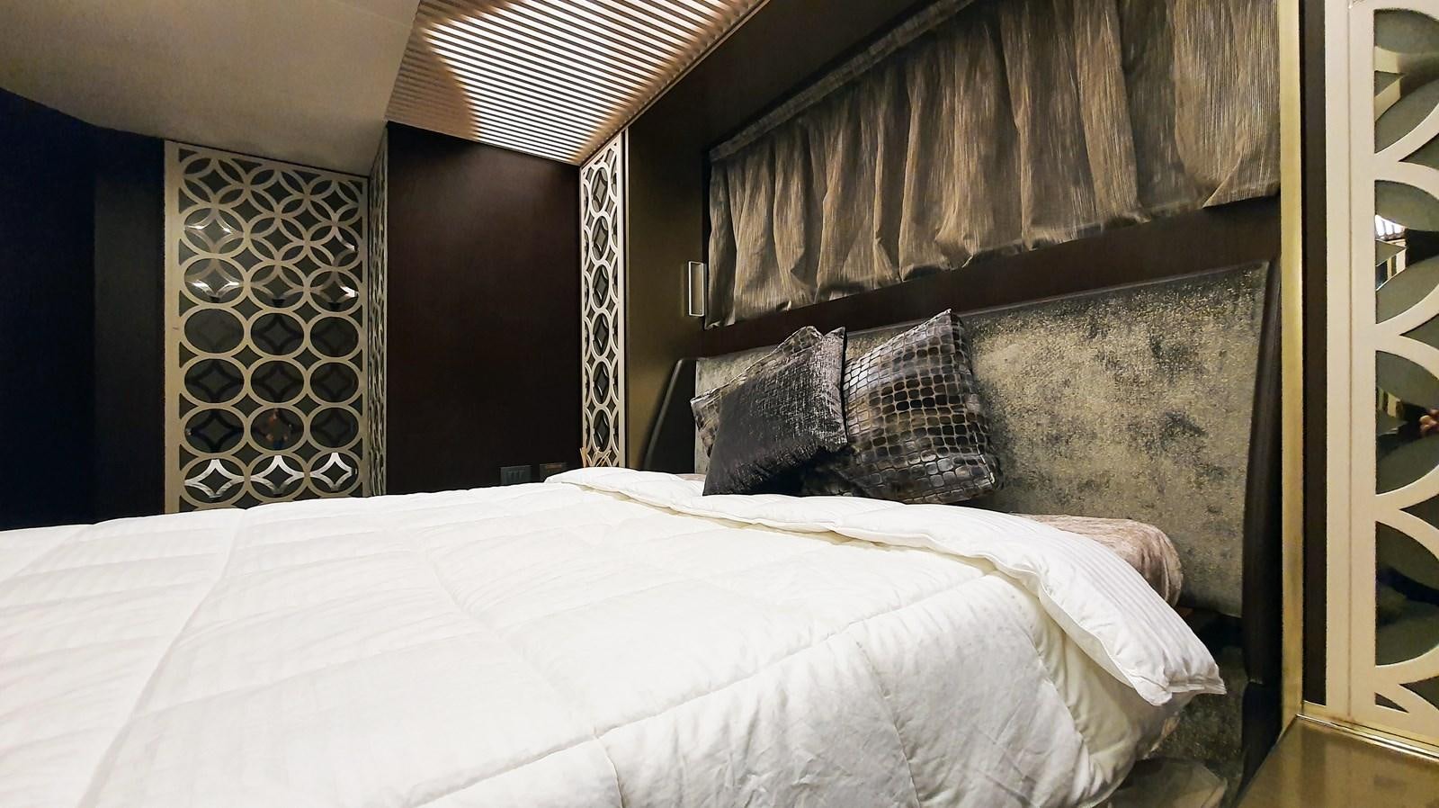 a bed with a white sheet and pillows aboard WHITE SHARK Yacht for Sale