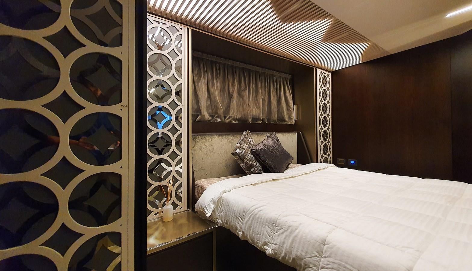 a bed with a white bed spread aboard WHITE SHARK Yacht for Sale