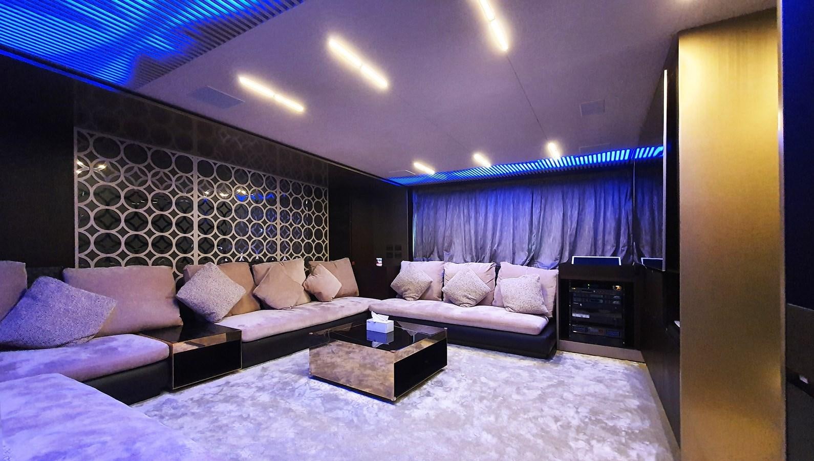 a bed with a couch and a table in a room with a large mirror aboard WHITE SHARK Yacht for Sale