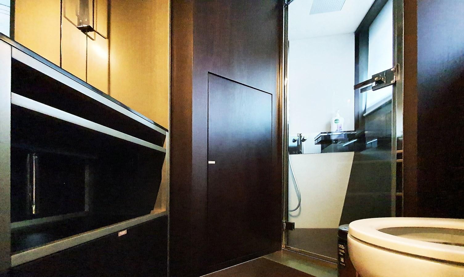 a bathroom with a wood door aboard WHITE SHARK Yacht for Sale