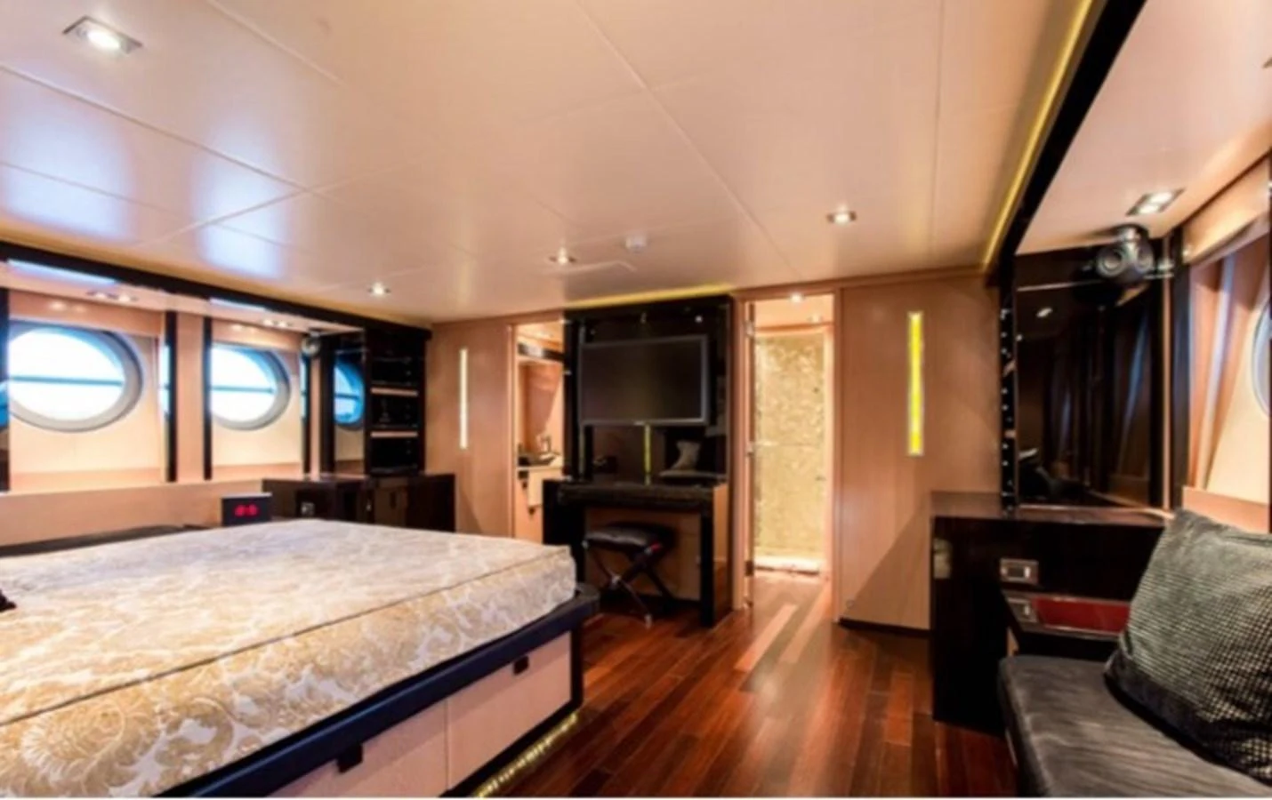 a bedroom with a bed and a desk aboard MY IZUMI Yacht for Sale