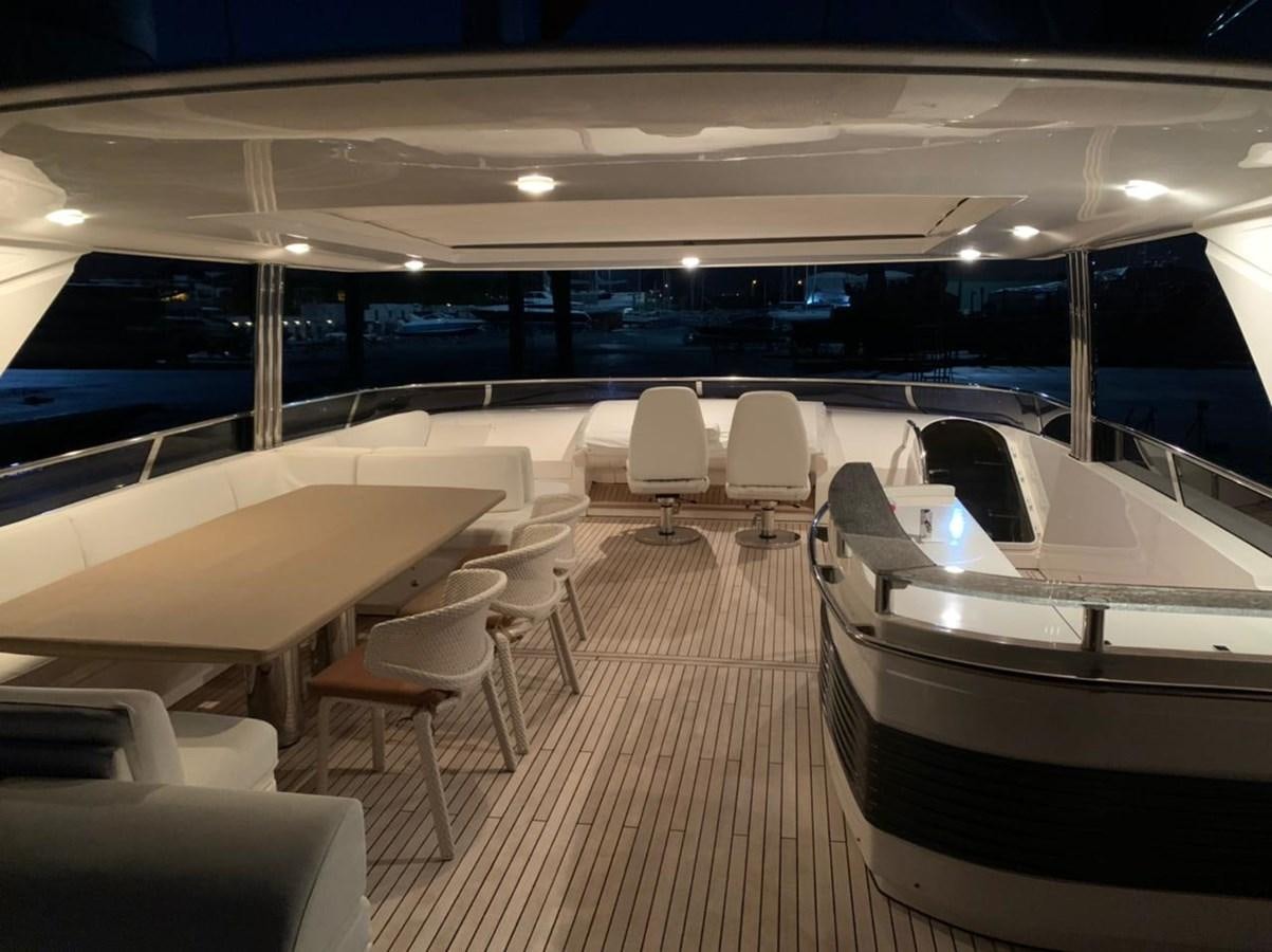 a room with a row of seats and a pool aboard SEA ARK Yacht for Sale