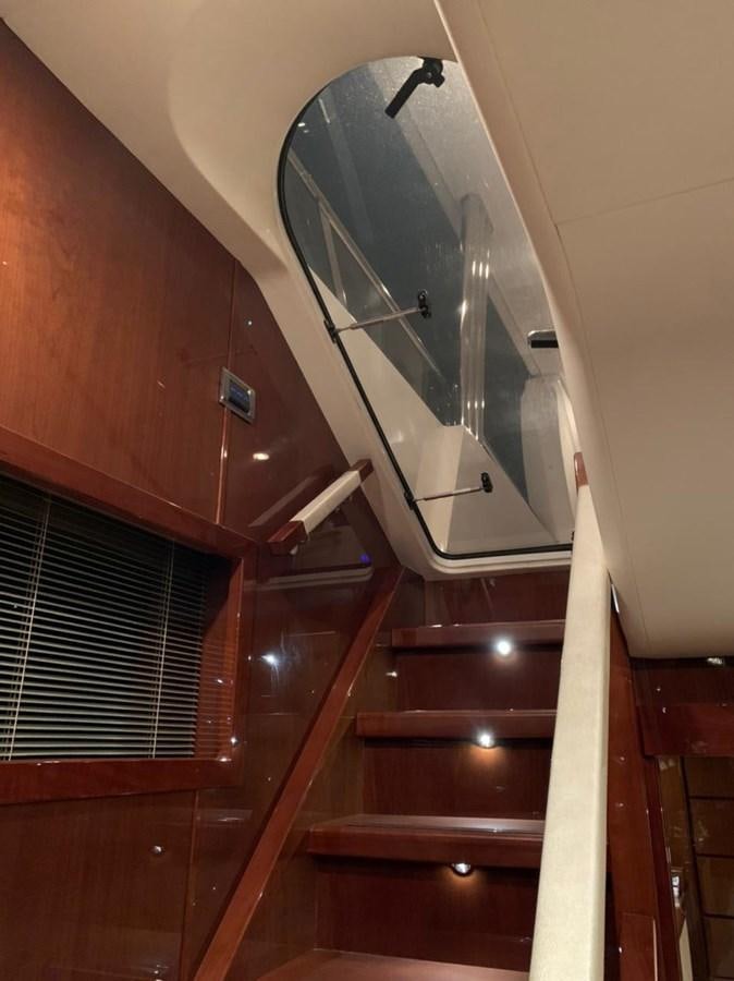 a staircase with a round mirror aboard SEA ARK Yacht for Sale
