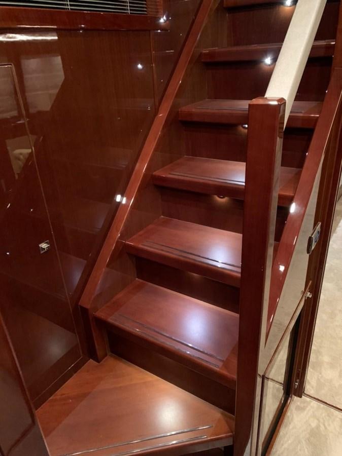 a wooden staircase with a glass door aboard SEA ARK Yacht for Sale