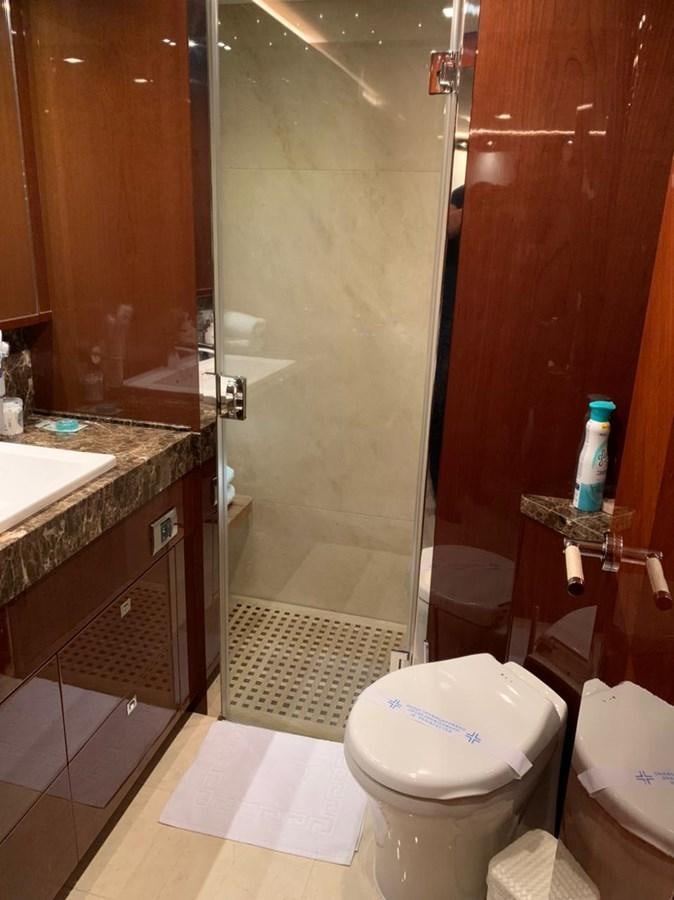 a bathroom with a toilet and a shower aboard SEA ARK Yacht for Sale