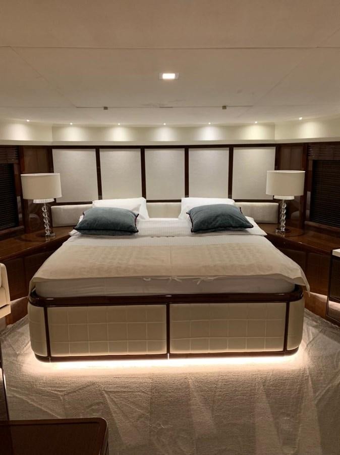 a large bed with a white comforter and pillows aboard SEA ARK Yacht for Sale