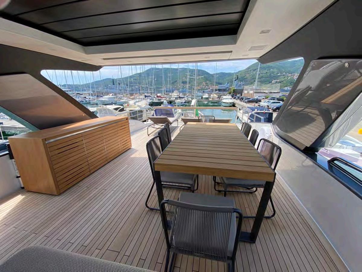 a table and chairs on a deck aboard MARITTA’S Yacht for Sale