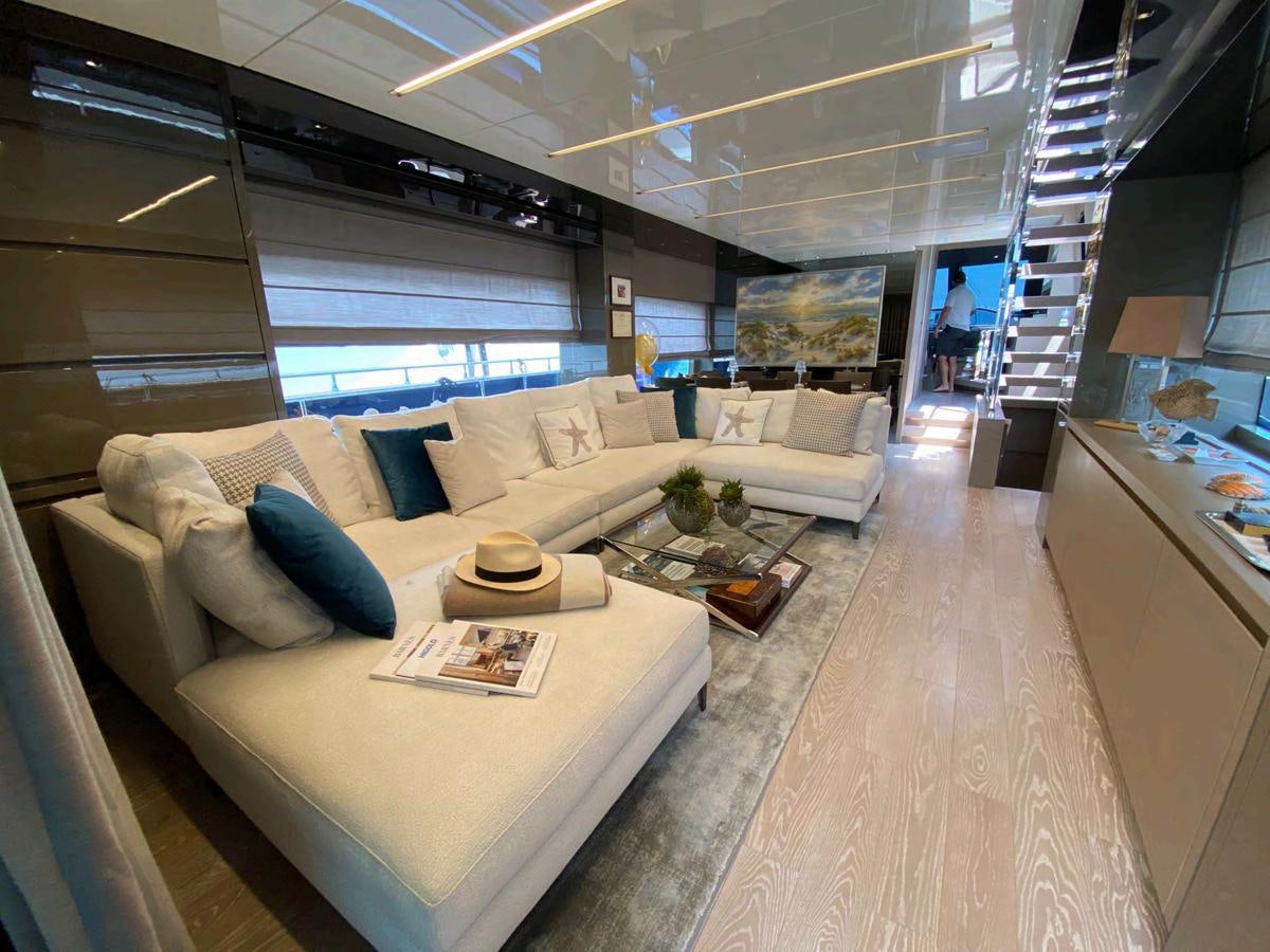 a living room with a large window aboard MARITTA’S Yacht for Sale