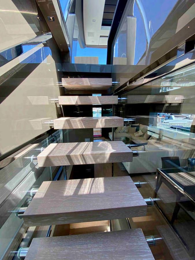 a staircase with a spiral staircase aboard MARITTA’S Yacht for Sale