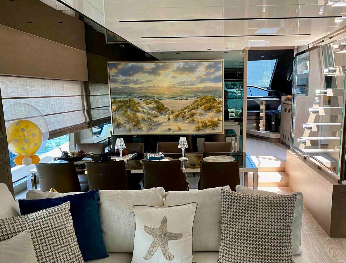 a room with couches and a tv aboard MARITTA’S Yacht for Sale