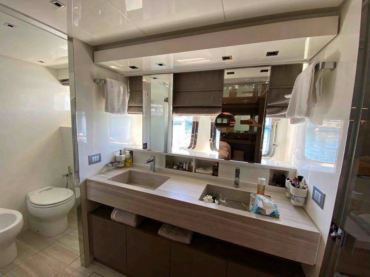 a bathroom with a large mirror aboard MARITTA’S Yacht for Sale