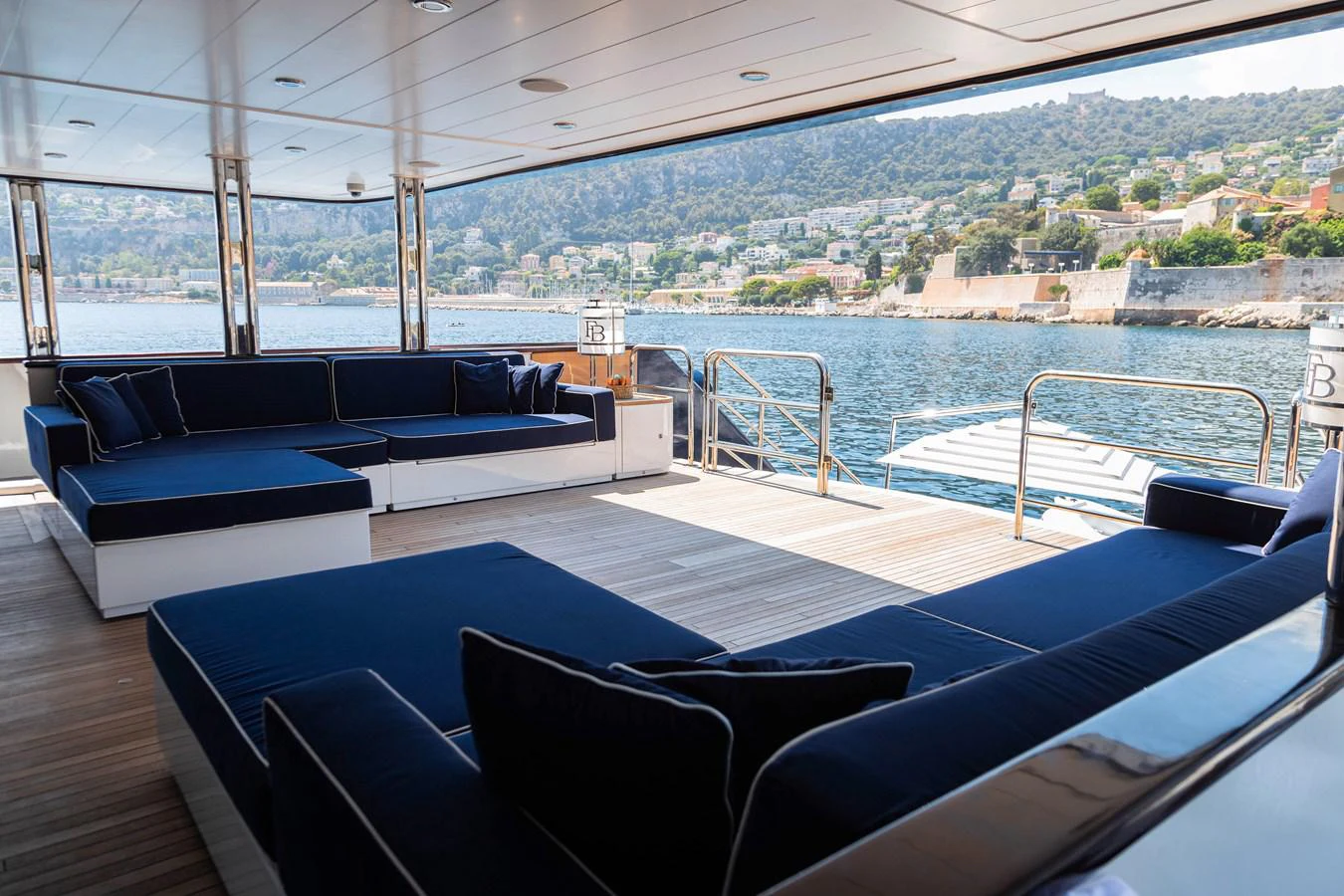 a large blue lounge chair on a deck overlooking a large body of water aboard FORCE BLUE Yacht for Sale