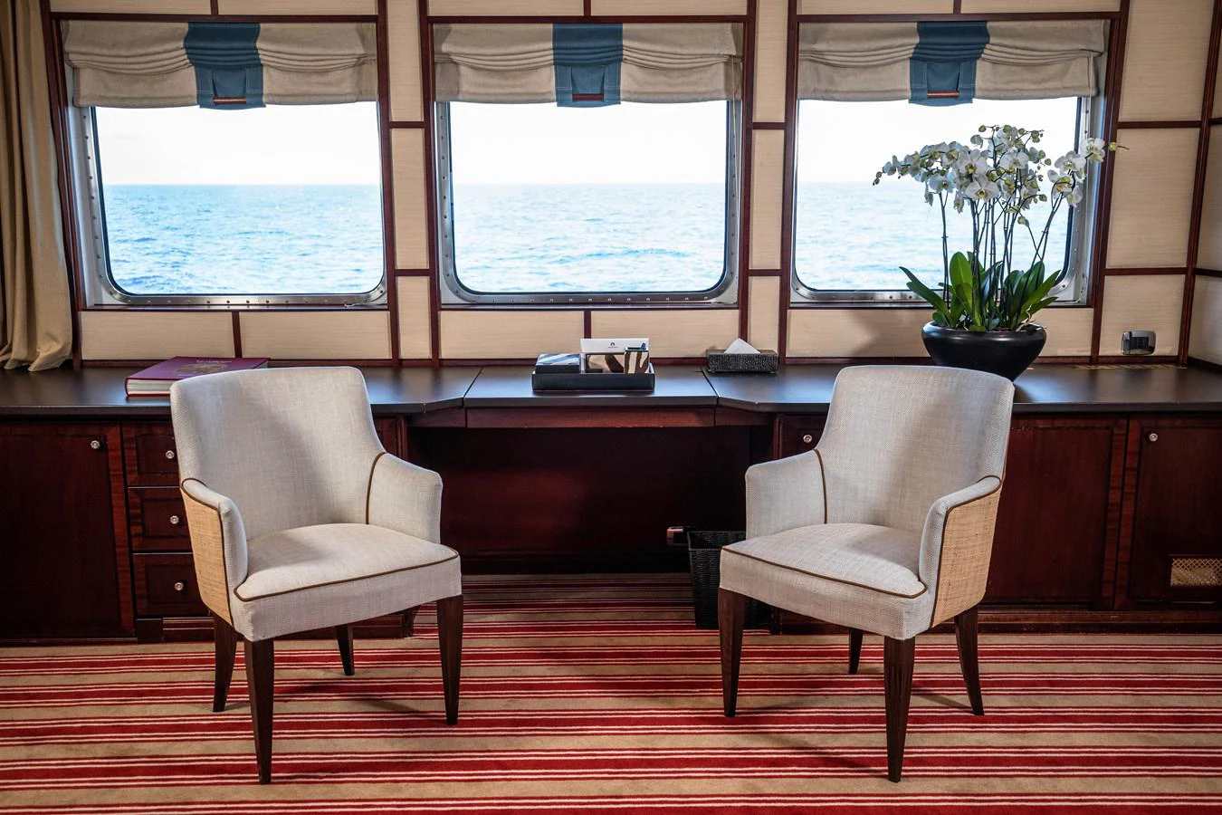 a couple of chairs sit in front of a window aboard FORCE BLUE Yacht for Sale