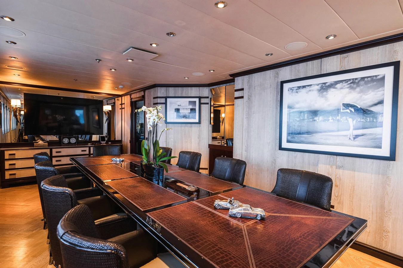 a large room with a table and chairs and a tv aboard FORCE BLUE Yacht for Sale