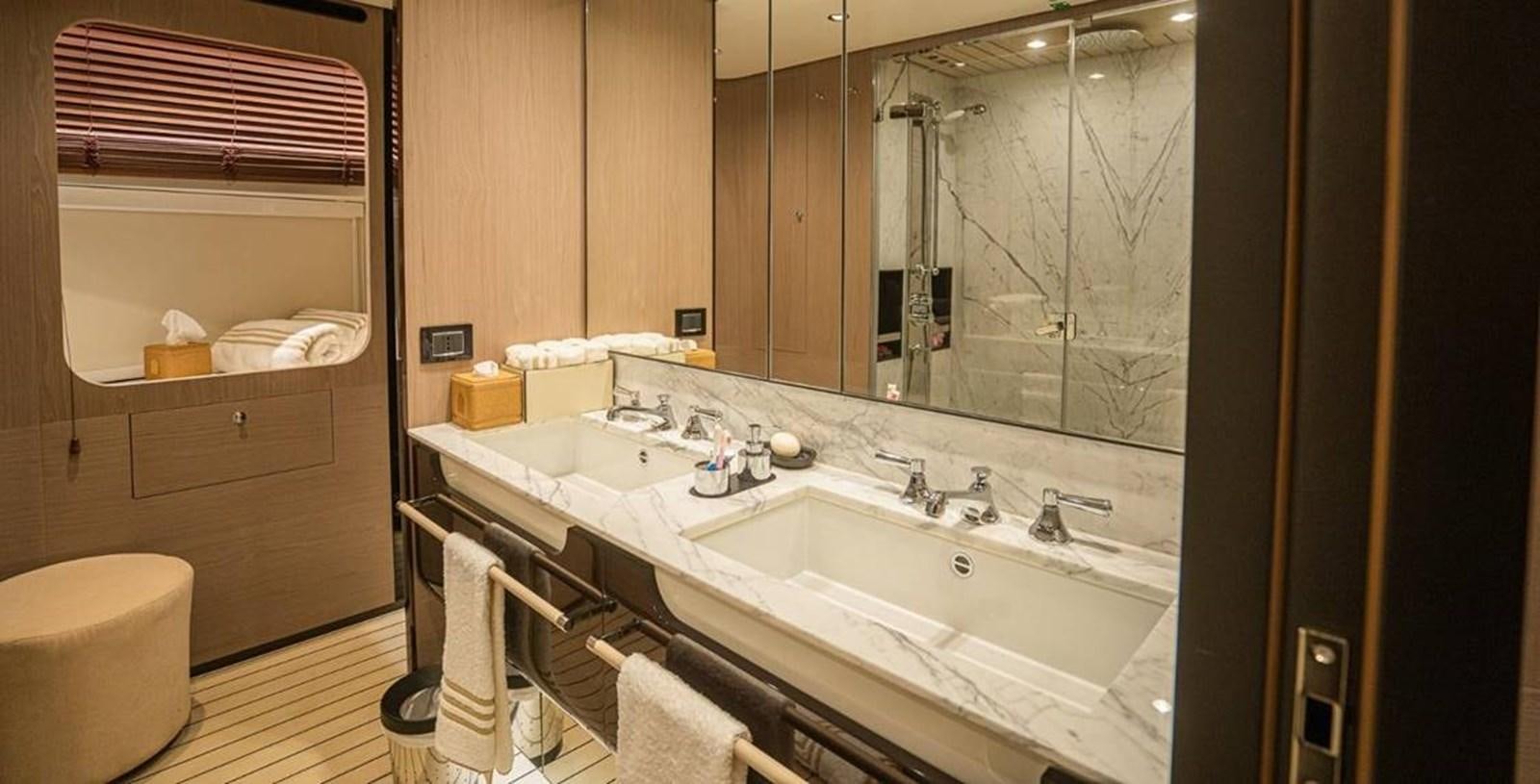 a bathroom with a large mirror aboard LULWA Yacht for Sale