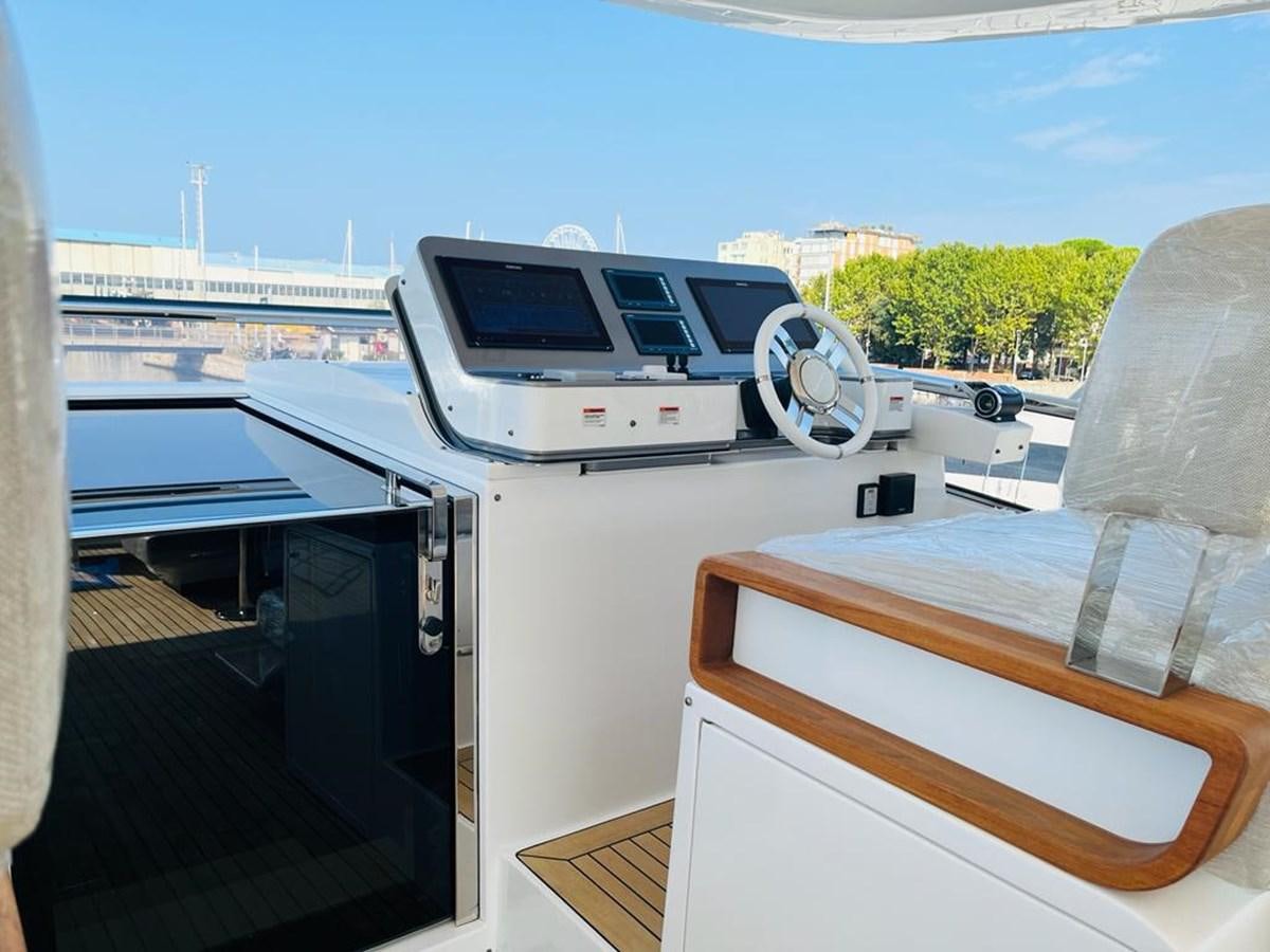 a deck with a boat and a large boat on it aboard LULWA Yacht for Sale