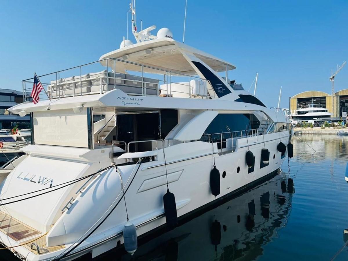 a white boat in a harbor aboard LULWA Yacht for Sale