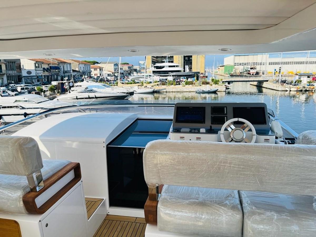 a room with a pool and a table with chairs and a building in the background aboard LULWA Yacht for Sale