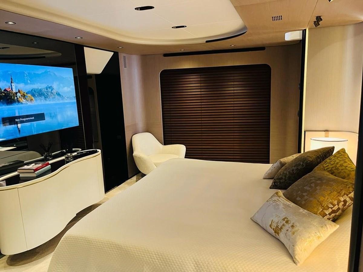 a bed with pillows and a television in a room aboard LULWA Yacht for Sale