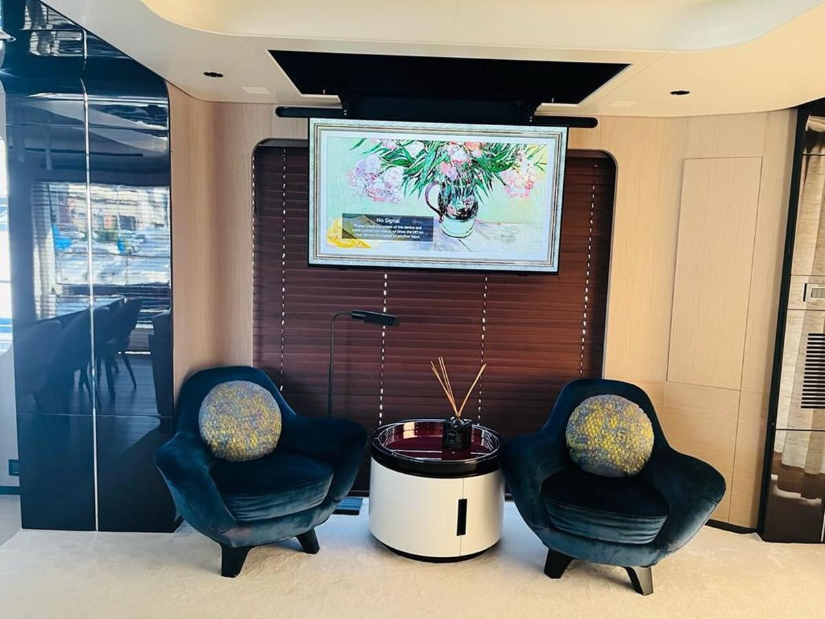 a living room with a large screen aboard LULWA Yacht for Sale