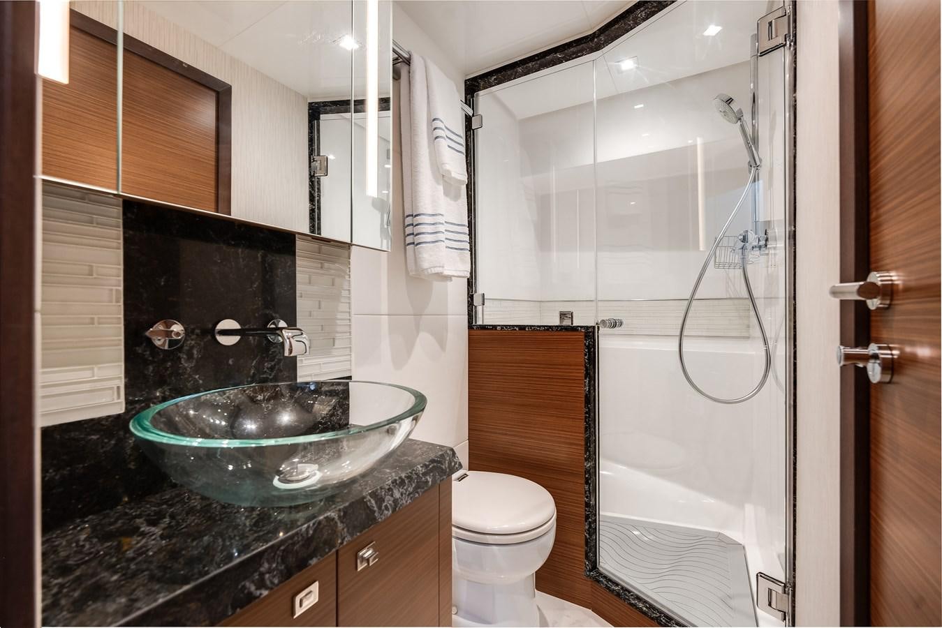 a bathroom with a glass shower aboard 2018 OCEAN ALEXANDER 70E TIRESUM Yacht for Sale