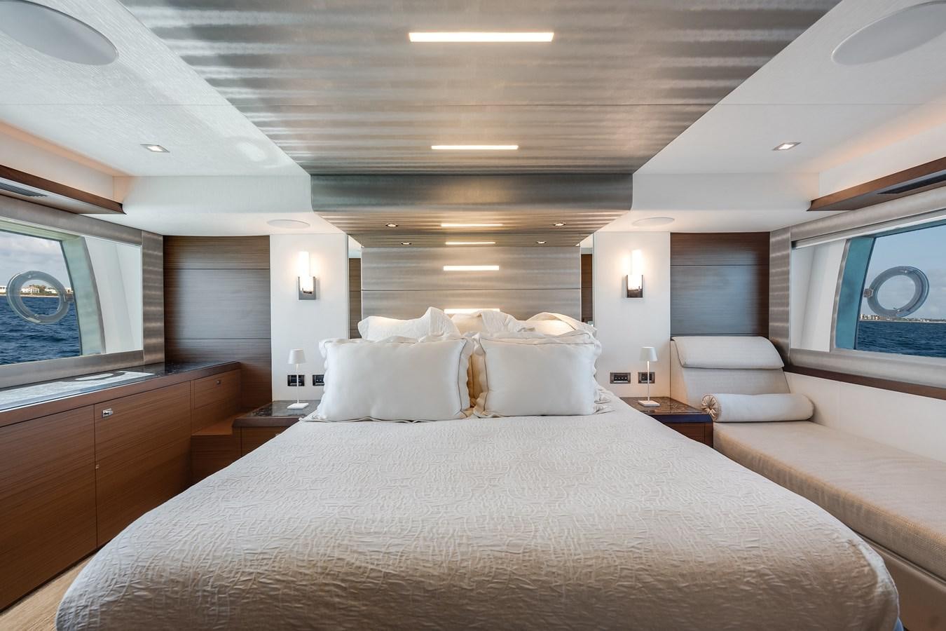 a room with a bed and a window aboard 2018 OCEAN ALEXANDER 70E TIRESUM Yacht for Sale