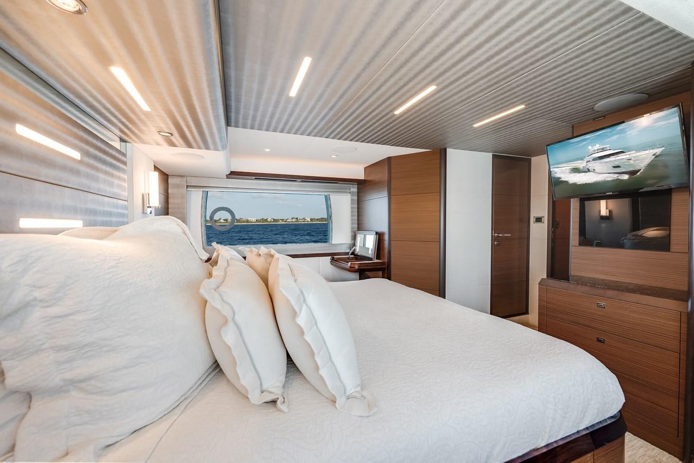 a bed with white sheets aboard 2018 OCEAN ALEXANDER 70E TIRESUM Yacht for Sale