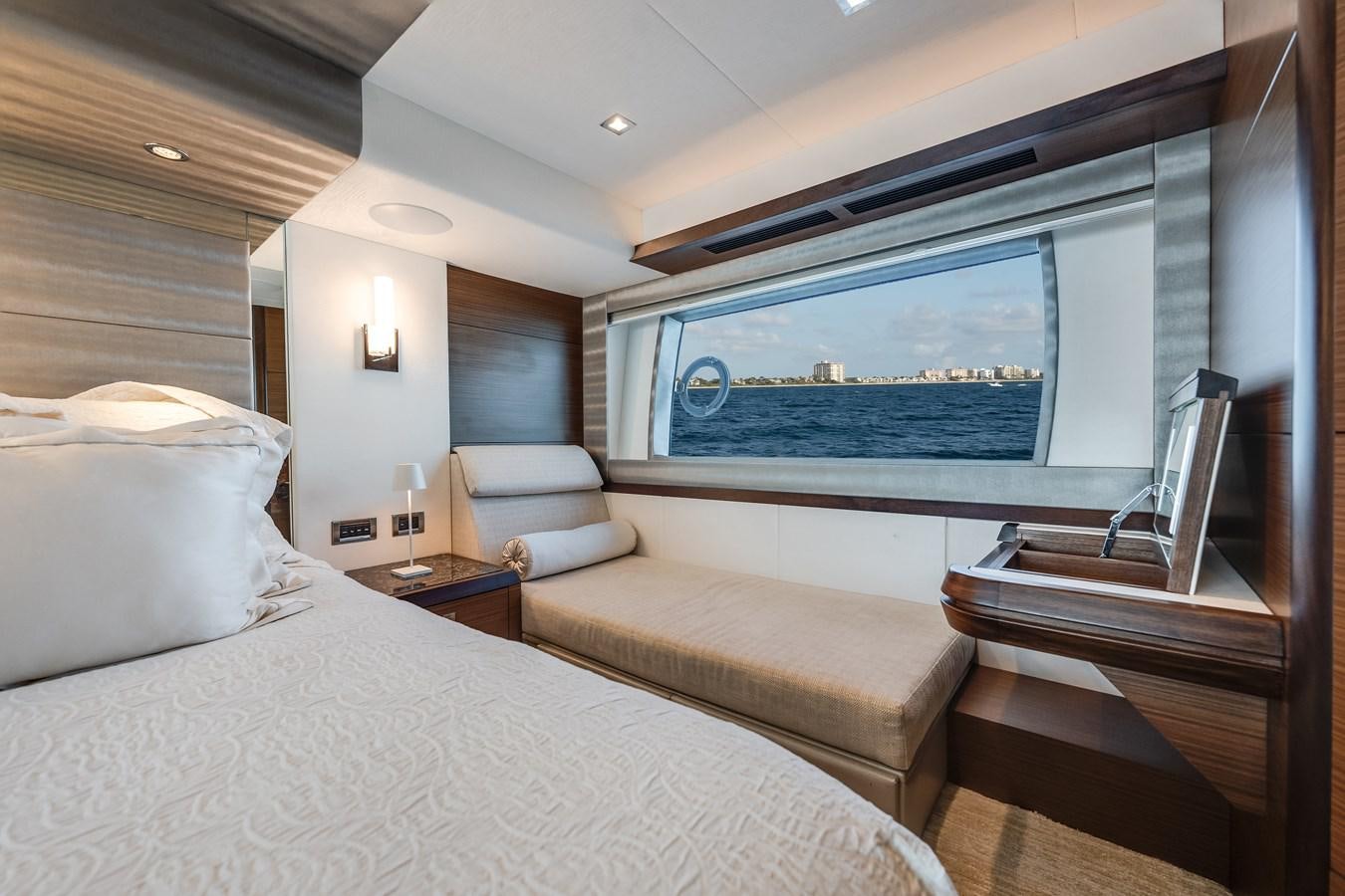 a room with a bed and a large window aboard 2018 OCEAN ALEXANDER 70E TIRESUM Yacht for Sale