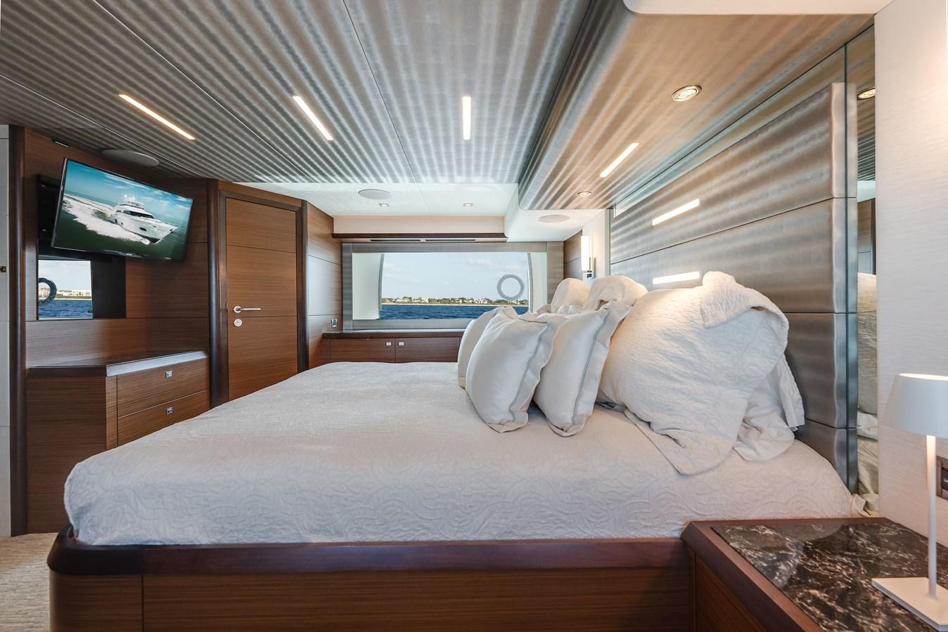 a bed with pillows on it aboard 2018 OCEAN ALEXANDER 70E TIRESUM Yacht for Sale