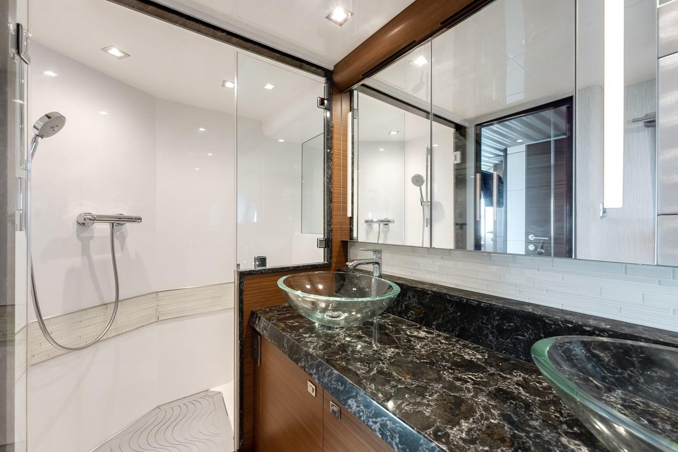a bathroom with a glass bowl aboard 2018 OCEAN ALEXANDER 70E TIRESUM Yacht for Sale