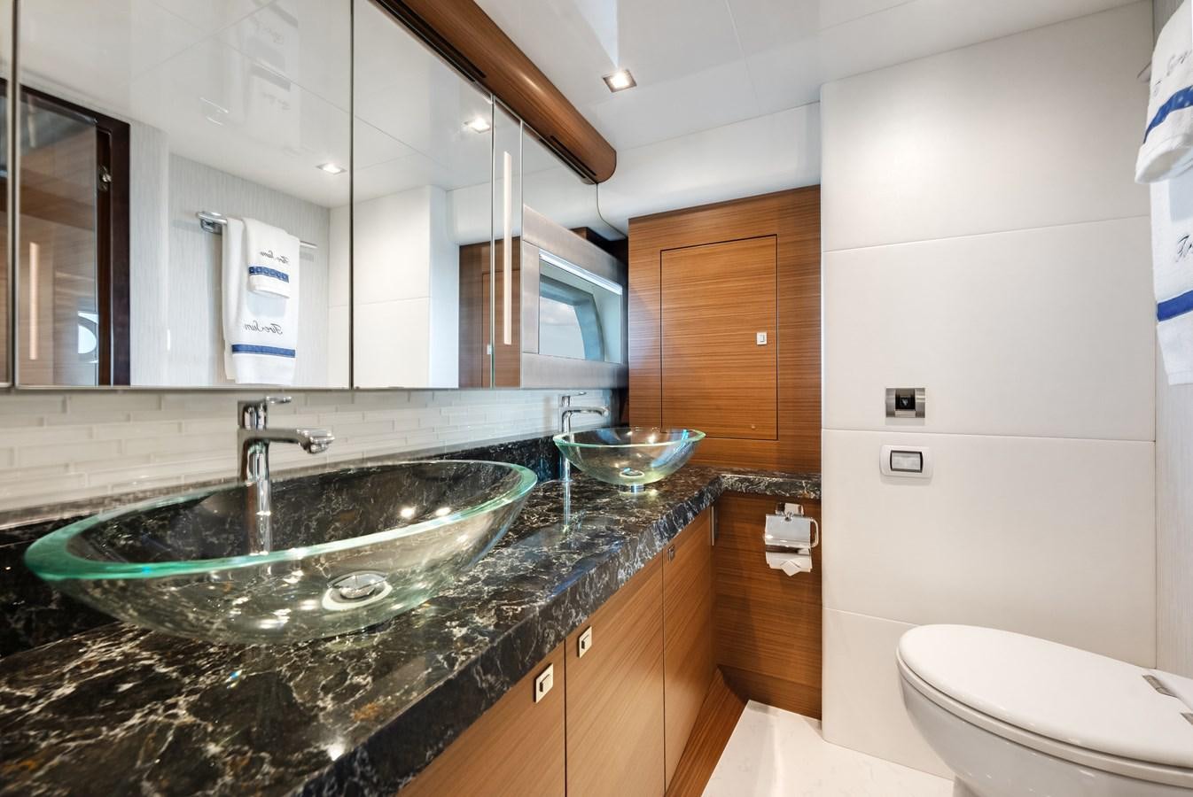 a bathroom with a sink and a mirror aboard 2018 OCEAN ALEXANDER 70E TIRESUM Yacht for Sale
