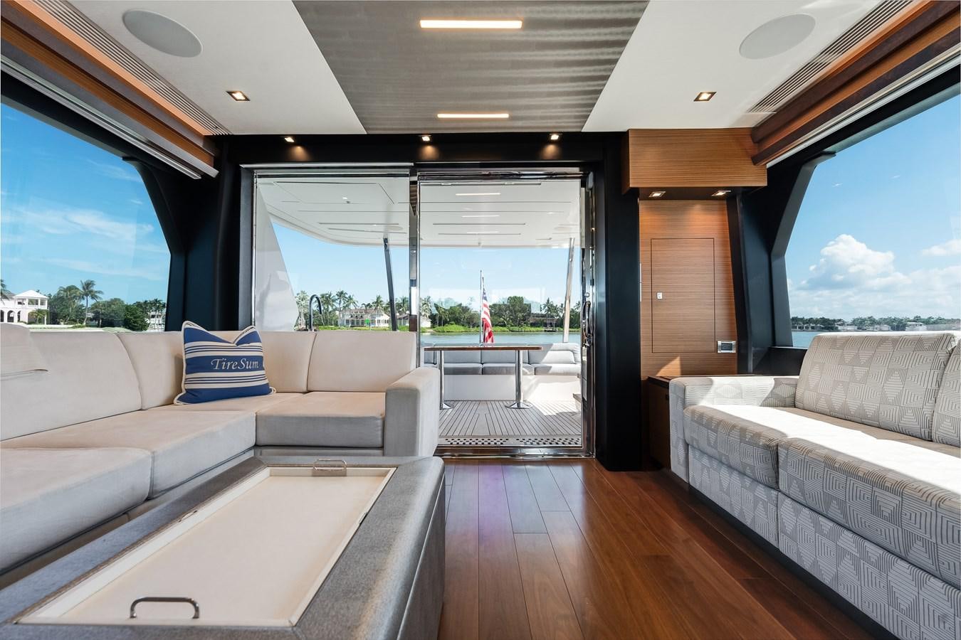 a living room with a large window aboard 2018 OCEAN ALEXANDER 70E TIRESUM Yacht for Sale