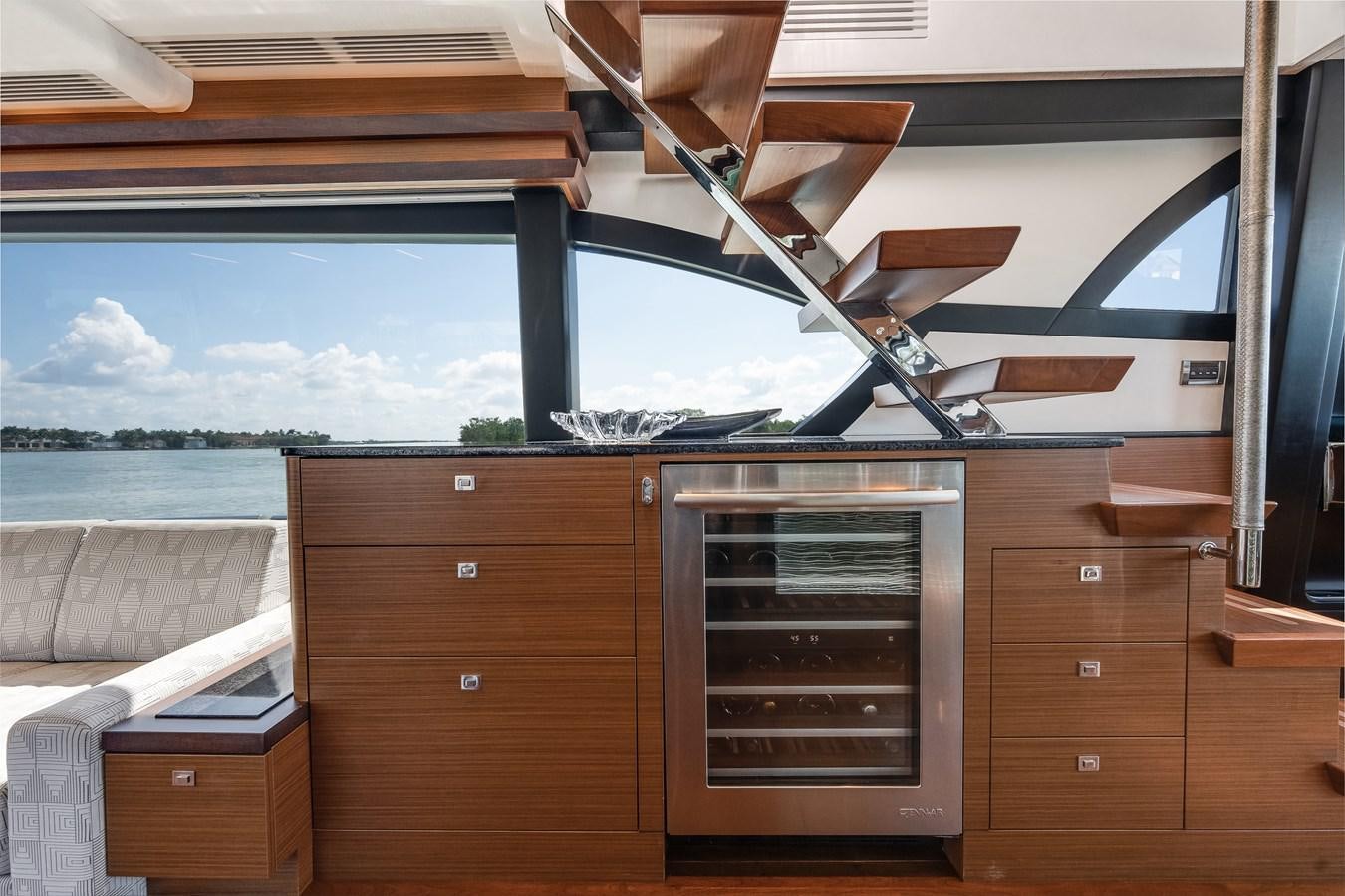 a wood cabinet with a chair on top of it aboard 2018 OCEAN ALEXANDER 70E TIRESUM Yacht for Sale