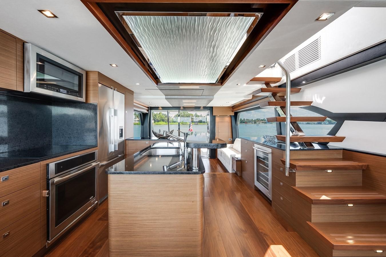 a modern kitchen with wooden floors aboard 2018 OCEAN ALEXANDER 70E TIRESUM Yacht for Sale