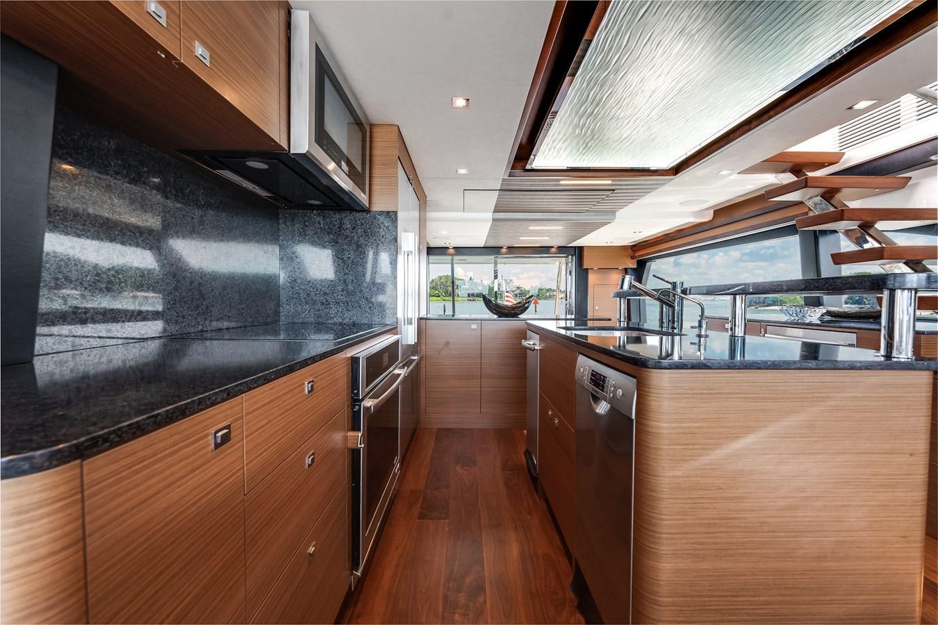 a kitchen with wooden cabinets aboard 2018 OCEAN ALEXANDER 70E TIRESUM Yacht for Sale