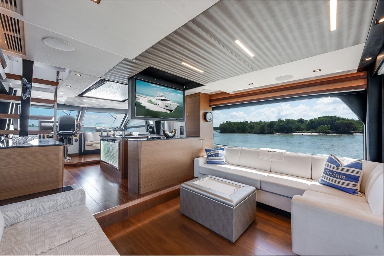 a room with a couch and a television aboard 2018 OCEAN ALEXANDER 70E TIRESUM Yacht for Sale