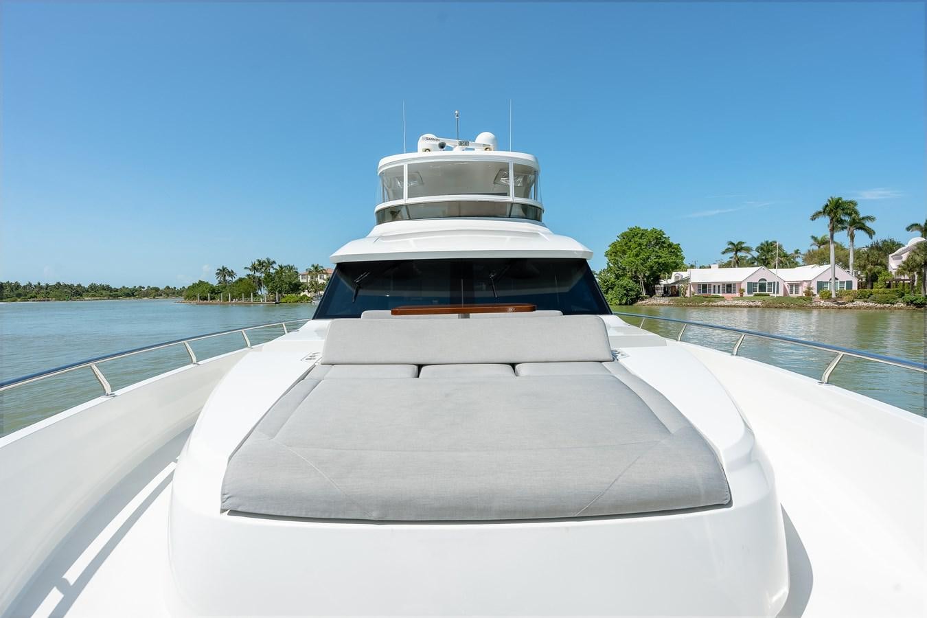 a white boat on a water way aboard 2018 OCEAN ALEXANDER 70E TIRESUM Yacht for Sale